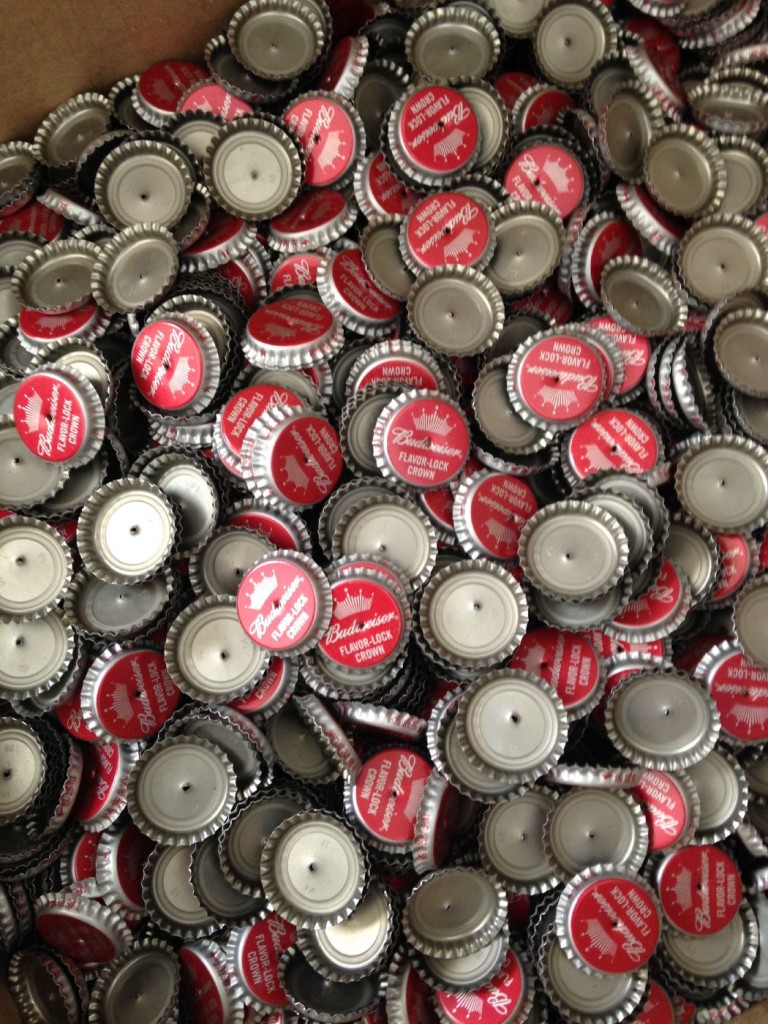 Punching holes in bottle caps