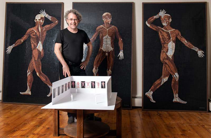 Artist John T. Unger with three completed mosaics and exhibition maquette