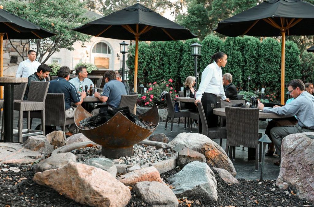 King Isosceles Sculptural Firebowl nestled among boulders between the entry and the patio at Redstone American Grill, Minnetonka, MN